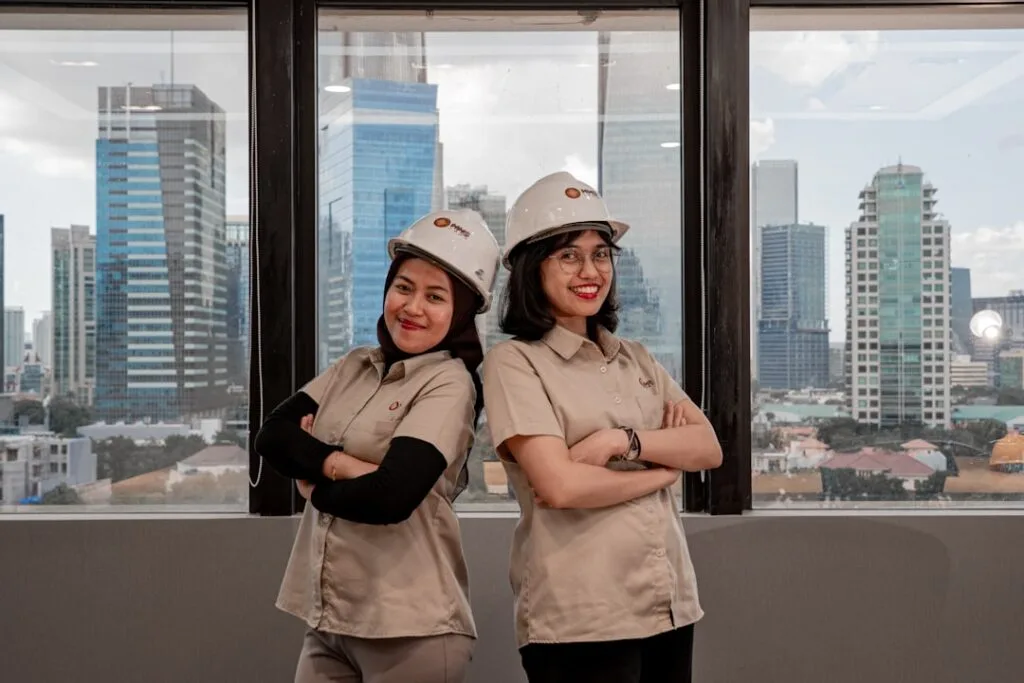Two women in hard hats and uniforms
